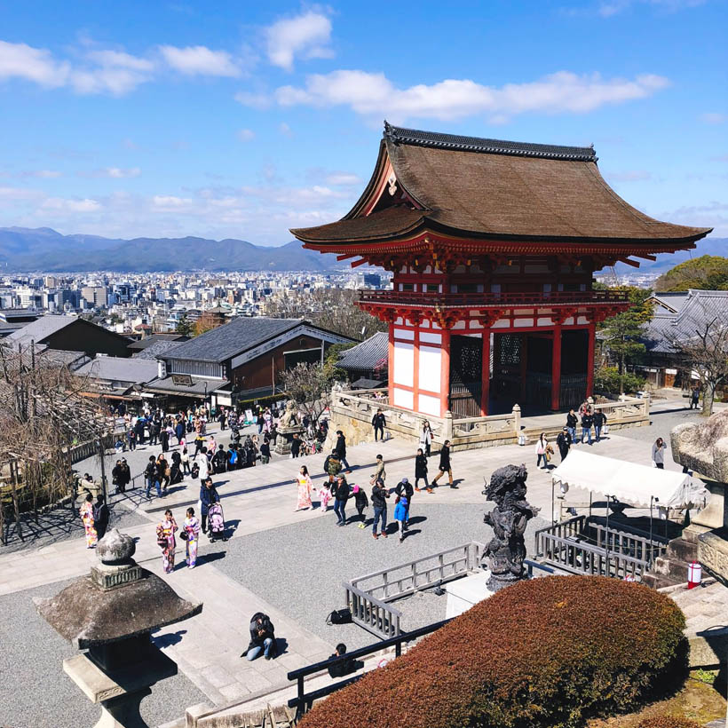 A gate at the Kiyomizudera complex, overlooking Kyoto and its surrounding mountains.