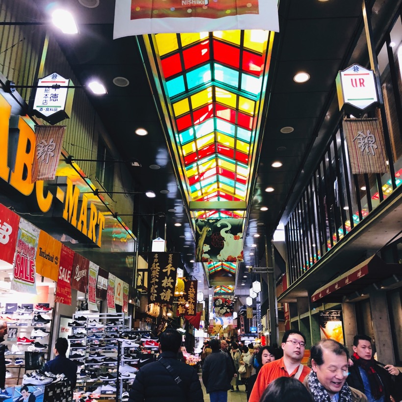 People walking in Nishiki Market in Kyoto, Japan.