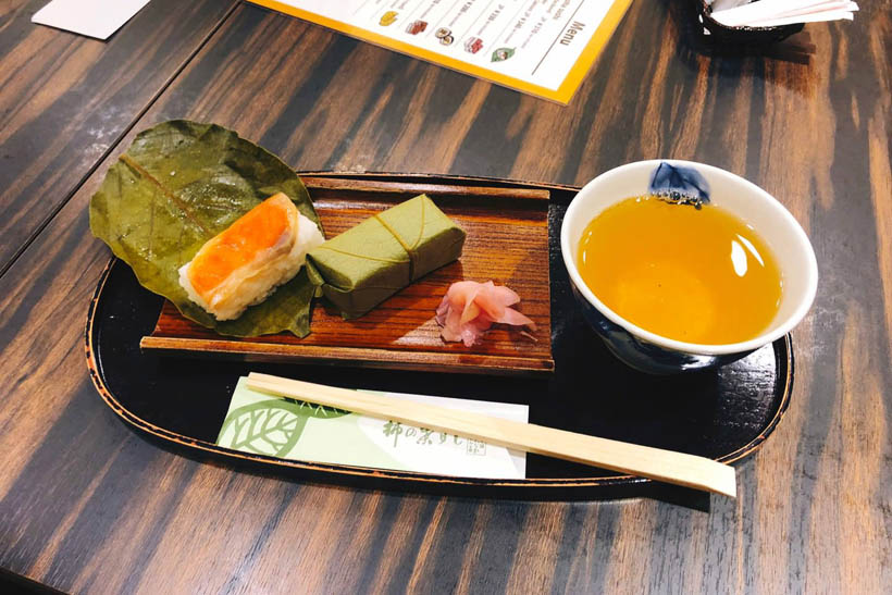 Persimmon leaf sushi with some green tea.