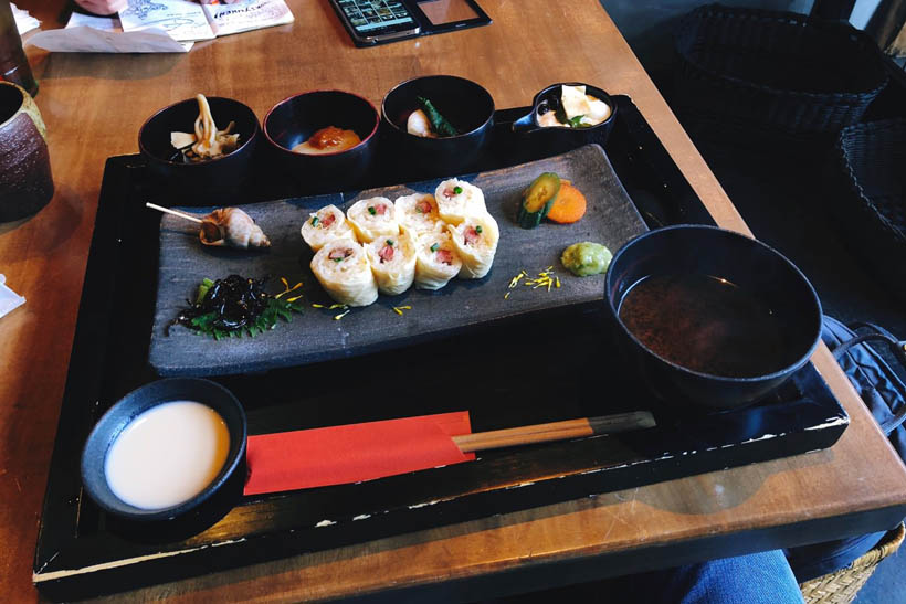 A yuba meal set at Zen in Nikko, Japan, with Wagyu beef wrapped in Yuba (tofu skin), some kind of tofu pudding, a bowl of miso soup and garnishes.