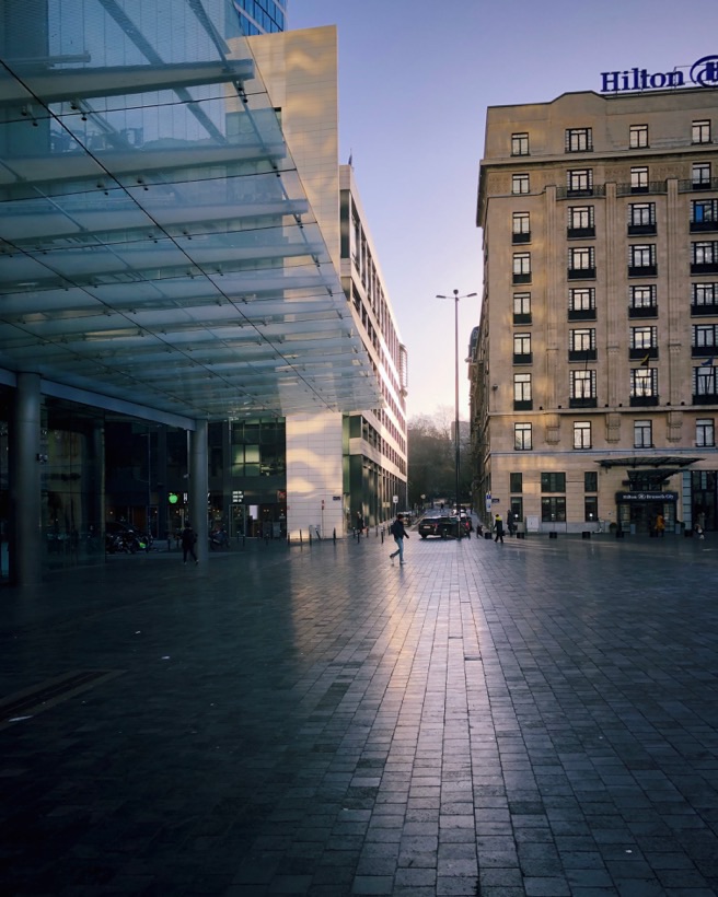 A picture of the sun rising at Place Rogier in Brussels.